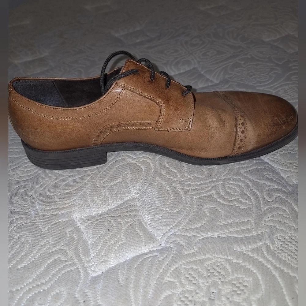 A pair of Cole Haan Oxfords in a men's size 12M. Pre-loved in good condition.